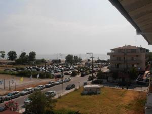 a parking lot with a lot of cars parked at Apartments Palladium in Olympiaki Akti