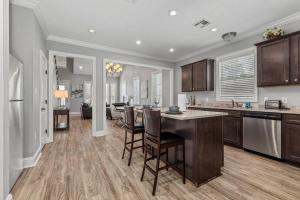 a kitchen and living room with a table and chairs at Luxury 2 Bedroom townhouse #6 in Lake Charles