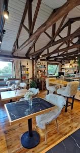 a room with tables and chairs in a building at Snow Valley Eco Lodge in São Joaquim