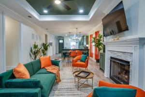 a living room with a green couch and a fireplace at Downtown escape: Lakes & Parks - 20min to Airport in Tallahassee