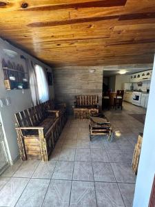 a living room with wooden ceilings and wooden furniture at The valley in Creel
