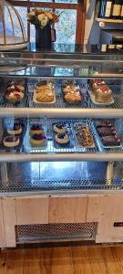 a display case with many different types of desserts at Snow Valley Eco Lodge in São Joaquim