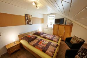 a bedroom with a bed and a chair in it at Haus Gretchen Alpen in Xanten