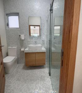 a bathroom with a sink and a toilet and a shower at Hotel Azomalli in Xochitepec