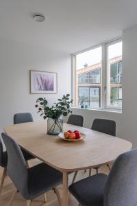 a dining room table with chairs and a bowl of fruit on it at Modern Villas in Plush town in Tromsø