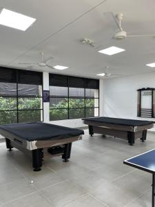 two ping pong tables in a room with windows at Apartamento Girardot Peñalisa con Piscina in Ricaurte