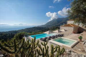 a villa with a swimming pool and a view of the ocean at Rachi Sea View White Villa in Episkopos