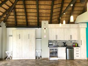 a kitchen with wooden cabinets in a room at LAKE-HOUSE CABIN in Witbank
