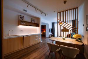 a kitchen with a sink and a wooden table at Hello Adventure in Sinaia