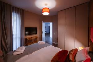 a bedroom with a large bed and a television at Hello Adventure in Sinaia +42 photos