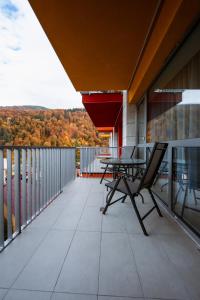 a balcony with a table and chairs on a building at Hello Adventure in Sinaia