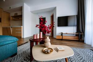 a living room with a vase on a table at Hello Adventure in Sinaia