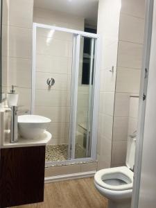 a bathroom with a toilet and a sink and a shower at Exclusive Stays @ Rea's Oceanic Hotels in Durban