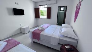 Cama ou camas em um quarto em Pousada Estrelar
