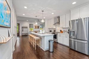 a kitchen with white cabinets and stainless steel appliances at Downtown 3 bedroom Townhouse in Lake Charles
