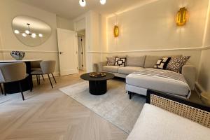 a living room with a couch and a table at Be London - Farringdon Apartments in London