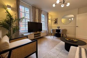 a living room with a television and a table at Be London - Farringdon Apartments in London