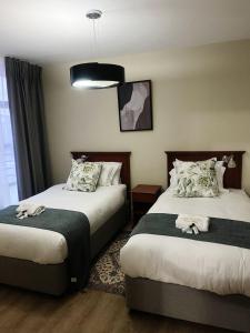 a hotel room with two beds and a window at Exclusive Stays @ Rea's Oceanic Hotels in Durban