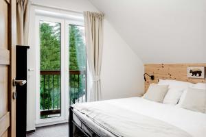 a bedroom with a bed and a window at Apartmán Bruno so saunou in Demanovska Dolina