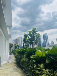 a balcony of a building with palm trees and a city at Quill 5 Star Residence in Kuala Lumpur