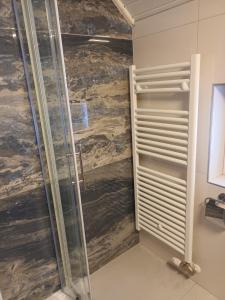 a shower with a glass door in a bathroom at Home away from home in Bohinj