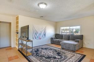 a living room with a couch and a tv at Bright Bisbee Home about 6 Mi to Downtown! in Bisbee
