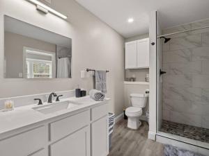 a white bathroom with a sink and a toilet at Beautiful 3 Bedroom Home in Lake Charles +17 photos