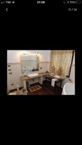 a bathroom with a sink and a mirror at La stanza dei segreti in Aosta