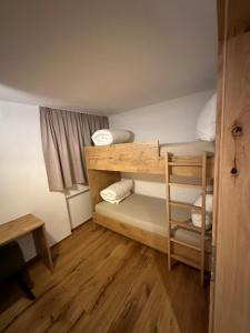 Mały pokój z łóżkiem piętrowym i biurkiem w obiekcie Ferienwohnung Krallinger w mieście Wenns