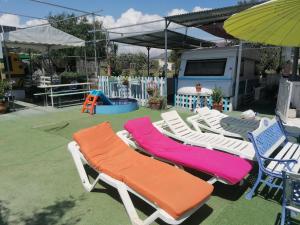 a group of lawn chairs and an umbrella at Habitaciones Don Pancho in Sax