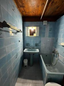 a bathroom with a sink and a tub and a toilet at Selena Rooms in Agia Galini
