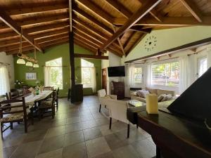 a large living room with a table and a couch at ESPINILLO 773 a 80 mts DEL GOLF CARILO in Ostende