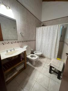 a bathroom with a sink and a toilet and a mirror at ESPINILLO 773 a 80 mts DEL GOLF CARILO in Ostende