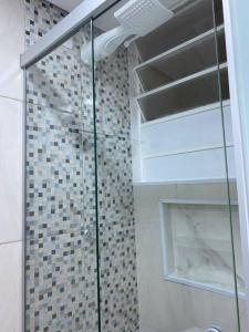 een douche met een glazen deur in de badkamer bij AP Smart Center in Campinas