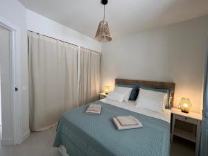 a bedroom with a bed with two towels on it at BLUE HORIZON Morro Jable in Morro del Jable