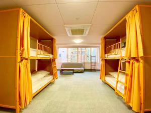 two bunk beds in a room with a window at Sakura Hotel Jimbocho in Tokyo