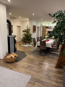 a living room with a christmas tree and a fireplace at Ferienhaus Hubertus für 8 Personen in Pill