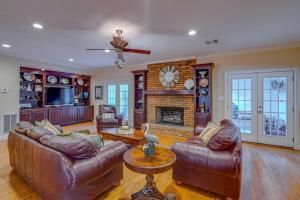 a living room with leather furniture and a fireplace at Yellow Adirondack Hideaway in Gulfport