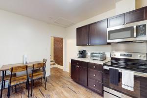 a kitchen with wooden cabinets and a wooden table at Market Street Memories in Frederick