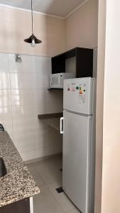 a kitchen with a white refrigerator and a counter at Depto moderno a metros de los portones del parque sobre calle Boulogne Sur mer in Mendoza