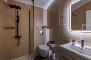 a bathroom with a shower and a toilet and a sink at Luxury Central Apartment 2 in Xanthi +26 photos