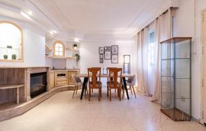 a dining room with a table and chairs and a fireplace at Casa grande piscina y garaje in Aljaraque