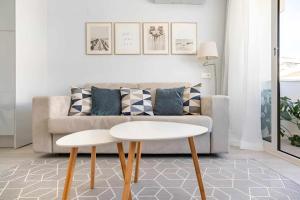 a living room with a couch and a table at Timeless Beach I Apartment in Armação de Pêra +29 photos