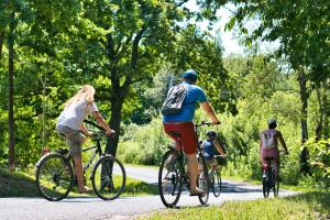 a group of people riding bikes down a road at Aracsa Farm és Vendégház Kis Balaton és termál fürdők in Egeraracsa