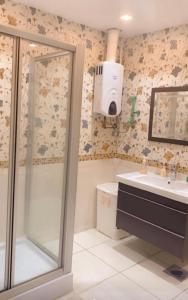 ein Bad mit einer Dusche und einem Waschbecken in der Unterkunft Hotel apartment in Kairo