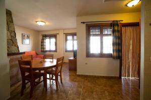 a living room with a table and a couch at Apartamentos Berrocal in Alcalá del Júcar