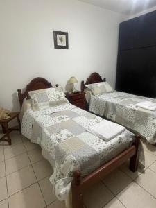 two twin beds in a room with at Casa Céntrica totalmente equipada !!! in Santiago del Estero