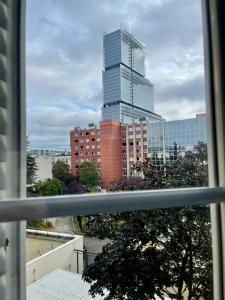 a view of a tall building from a window at AIR CONDITIONING - METRO 14 - CHARMING TRADITIONAL STYLE AND MODERN ACCESS 10 MN AWAY FROM CENTER Of PARIS in Clichy