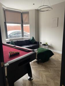 a living room with a pool table and a couch at Luxury Home in Blackpool in Blackpool