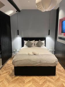 a bedroom with a large bed with two tables at Luxury Home in Blackpool in Blackpool